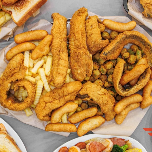 A'Nets Katch seafood platter with fried fish, shrimp, fries, hush puppies, and fried okra.