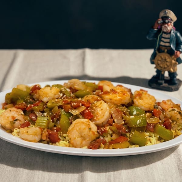 A'Nets Katch shrimp and vegetables over rice, with a small captain figurine in the background.