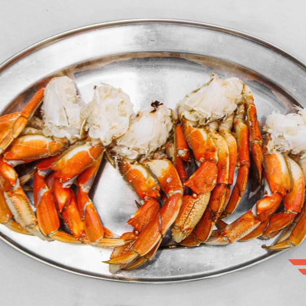 A'Nets Katch's steamed crab legs and claws with white meat on a silver platter.