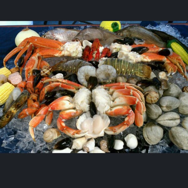 A'Nets Katch seafood platter with crabs, fish, lobster, shrimp, mussels, clams, and corn on ice.