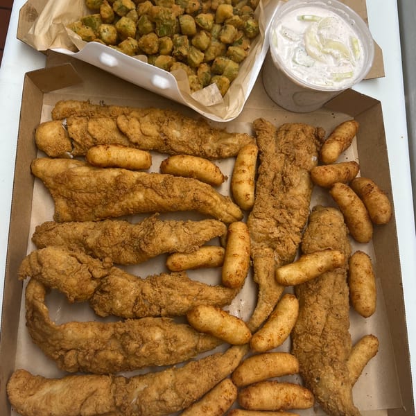 A'Nets Katch fried fish and hush puppies in a box, with fried okra and tartar sauce.
