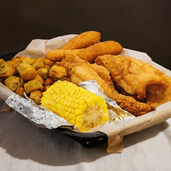 A'Nets Katch seafood platter with fried fish, hush puppies, fried okra, and corn on the cob.